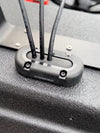 Three black cables entering a vertical Scanstrut seal on a textured black surface
