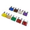 Group of colour-coded maxi blade fuses ranging from 20A to 100A laid out on a white background