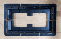 Overhead layout view of four corner brackets and two mid brackets arranged on a wooden surface