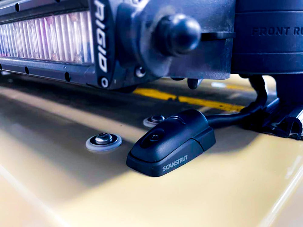 Close-up of cable seal on a vehicle roof routing power to an LED light bar
