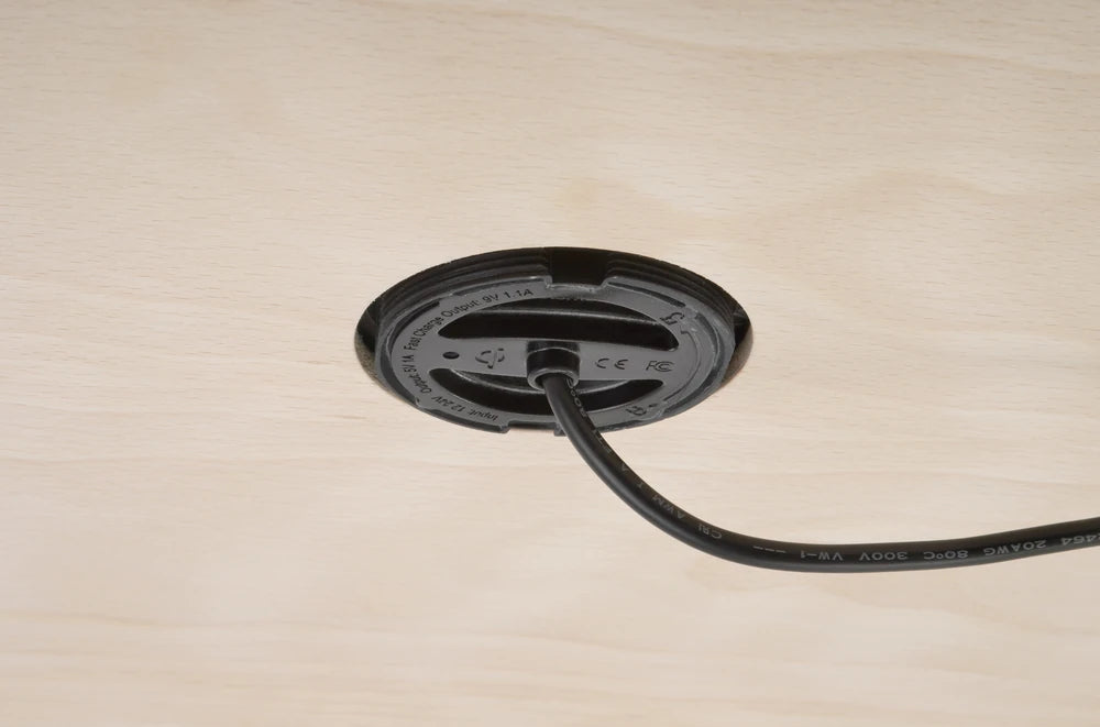 Underside of recessed wireless charger showing mounting through timber panel