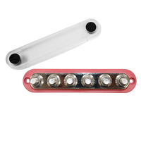 Red 300A busbar with six M10 studs and a detached clear protective cover next to it
