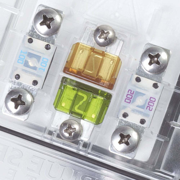 Close-up of ATO/ATC fuse sockets with installed fuses and spare puller tool