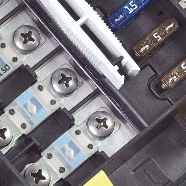 Macro view of MIDI/AMI high-amperage fuses secured with screws