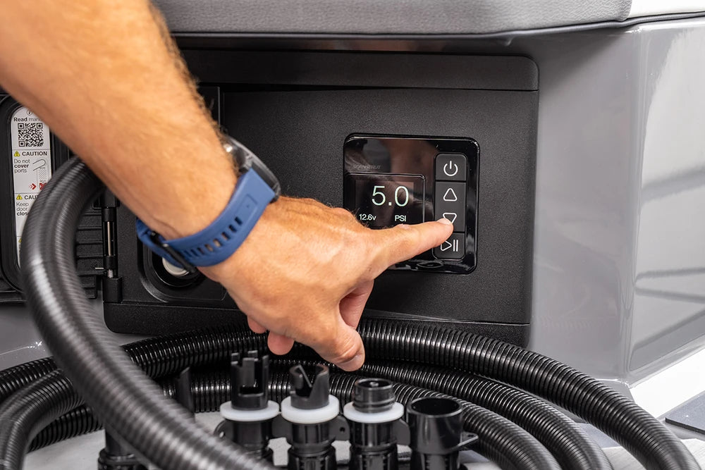 Close-up of a person's finger pressing buttons on the Scanstrut ATMOS digital interface