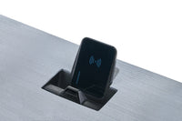 Flush-mounted Scanstrut Aura wireless charger on a grey textured benchtop