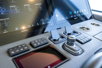 Multiple Aura wireless chargers installed on a modern boat helm dashboard