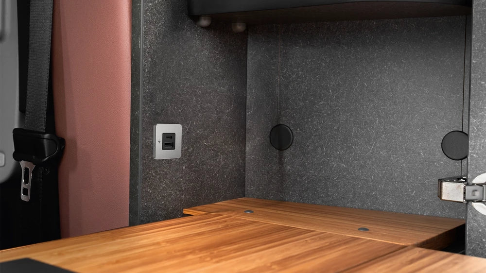 Installed TILE USB socket on a textured interior panel of a van