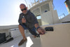 Man using the Scanstrut Ventura quick-connect water outlet on a boat