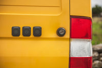 Three Scanstrut Ventura sockets installed on the side of a yellow adventure van