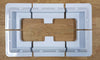 Top-down view of six-piece solar panel mounting kit arranged in rectangular formation on wooden surface