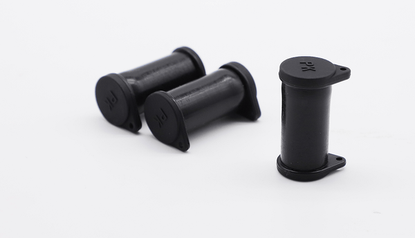 Three black solar connector caps arranged to show side profiles and the closed top with PK marking