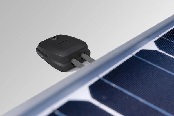 Double cable seal routing grey solar cables through a white vehicle roof
