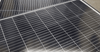 Macro detail shot of photovoltaic cells showing fine electrical grid lines on the panel surface