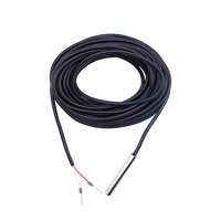 Coiled black temperature sensor cable with stainless steel probe and stripped wire leads