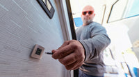 Hand plugging a USB-C cable into the installed brushed stainless socket in a boat cabin