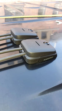 Side view of dual horizontal cable entry seals on a dark vehicle roof