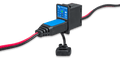 Victron battery indicator panel with status LEDs and charging cable plugged into the interface