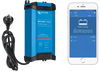Blue battery charger with AU power plug and smartphone showing Bluetooth app interface