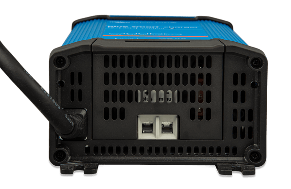 Bottom view of battery charger showing ventilation grille and DC output terminals