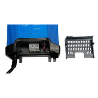 Close-up of battery charger terminals with protective cover removed revealing the internal fuse