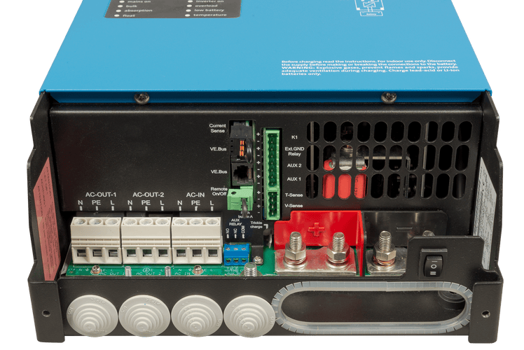 Internal view of connection terminals including AC input, AC outputs, and DC battery bolts