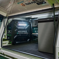 Enerdrive Voyager system with white light active in a 4WD canopy alongside a fridge