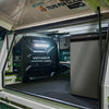 Enerdrive Voyager system with white light active in a 4WD canopy alongside a fridge