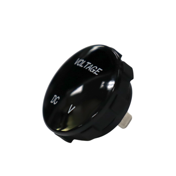Angled front view of round black voltmeter gauge displaying VOLTAGE and DC V text