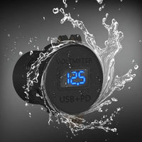 Water splashing around the socket with closed dust cover, showing the blue voltage reading through the clear window