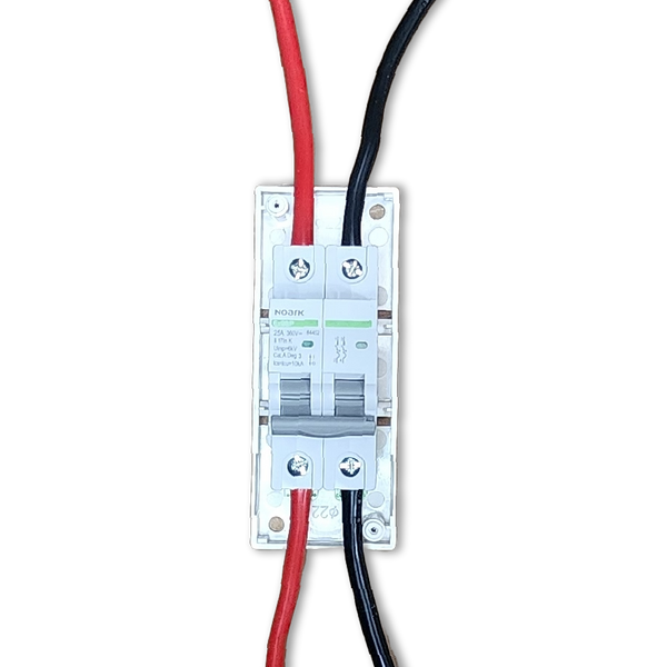 Top-down view of DC circuit breaker with red and black cables connected to bottom terminals